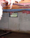 Montana crawl space with vents, showing mold, rot, and fiberglass insulation dripping off the ceiling.