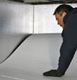 contractor installing TerraBlock™ floor insulation in a Columbus crawl space