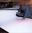 Roundup insulation being installed in a crawl space.