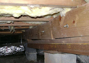 sagging crawl space with wooden shimming a Colstrip crawl space