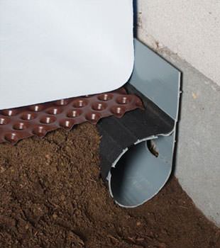 Closeup of a crawl space drainage system installed in Stanford