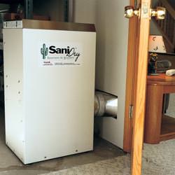 A basement dehumidifier with an ENERGY STAR® rating ducting dry air into a finished area of the basement  in Busby