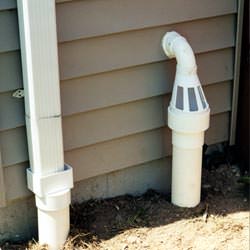 A grated sump pump discharge line fitting in Bridger