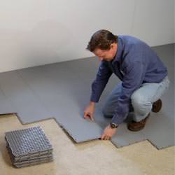 basement subfloor tiles being installed by a contractor in Hays