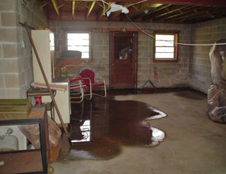 a flooded basement floor in a Busby home