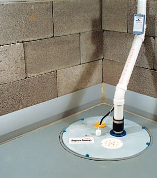 A baseboard basement drain pipe system installed in Forsyth
