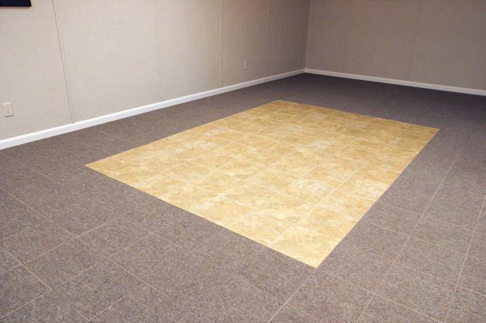 tiled and carpeted basement flooring installed in a Laurel home