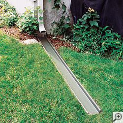 A gutter downspout extension installed in a Park City lawn.