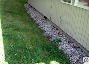 A yard that has been graded to slope towards the foundation in Absarokee