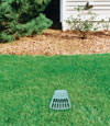 A buried gutter drain downspout extension installed in a Busby home