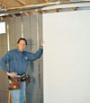Installing wall panels on top of our basement wall insulation in Roundup